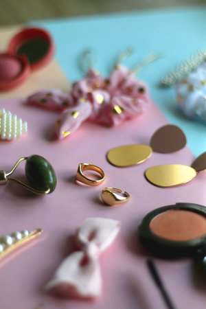 Various accessories, make up products and jewelry on various colorful pastel backgrounds. Selective focus.の写真素材
