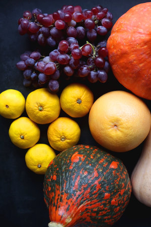 Various fresh and healthy autumnal fruit and vegetable. Top view, dark background.の写真素材