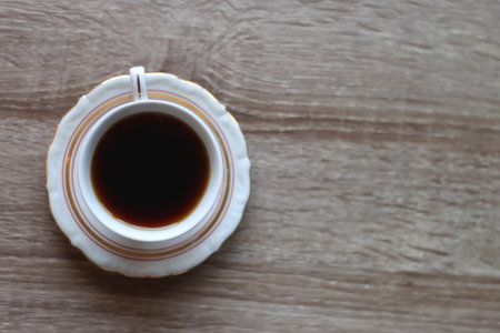 Cup of tea on wooden table. Top view.