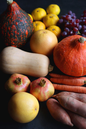 Various fresh and healthy autumnal fruit and vegetable. Selective focus, dark background.の写真素材
