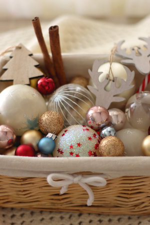 Basket with various Christmas ornaments and knitted blanket. Selective focus.の写真素材