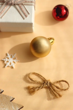 Small presents and various Christmas ornaments on neutral background. Selective focus.
