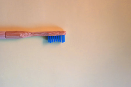 Sustainable wooden toothbrush on pastel yellow background. Top view.の写真素材