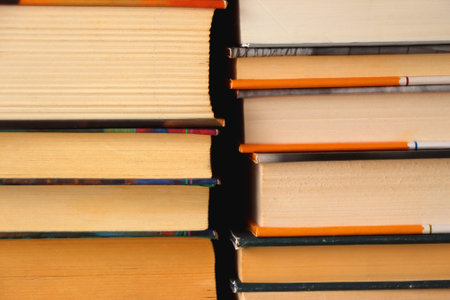 Big pile of books on the table.