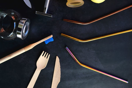 Various sustainable beauty products and kitchen utensils on dark background. Top view.