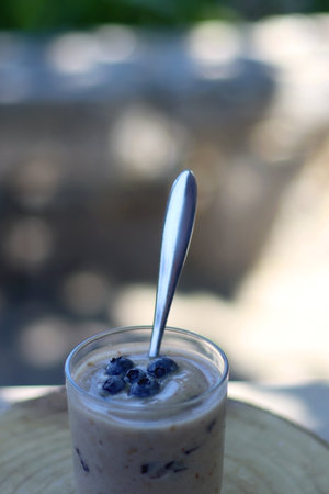 Vegan banana nice cream with blueberries, served in a garden. Selective focus.の写真素材