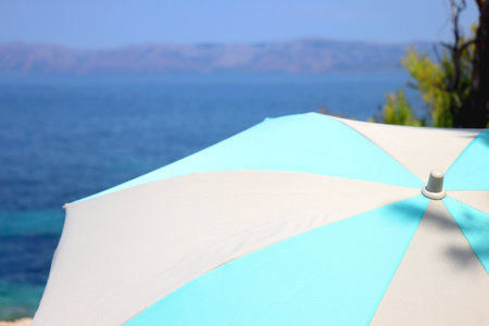 Colorful parasol on the beach, on island Korcula, Croatia. Sunny summer day. Selective focus.の写真素材