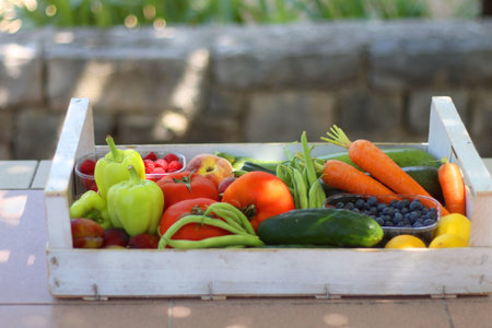 Wooden crate full of healthy seasonal fruit and vegetable, in the garden. Selective focus.の写真素材