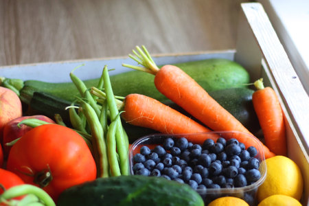 Wooden crate full of healthy seasonal fruit and vegetable. Selective focus, wooden background.の写真素材