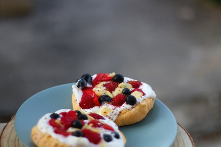 Two small homemade pavlova cakes, served in the garden. Selective focus.