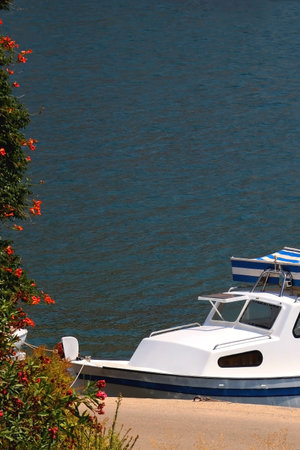 Small rustic boat on the promenade. Picturesque scene from Croatia.の写真素材