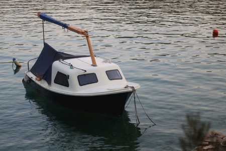 Small rustic boat on the promenade. Picturesque scene from Croatia.の写真素材