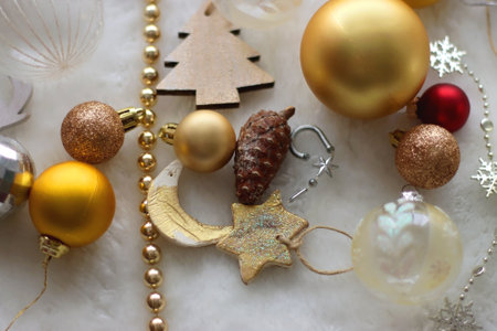 Various colorful Christmas oranments and white faux fur blanket. Selective focus.の写真素材