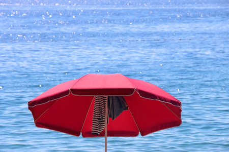 Colorful parasol on the beaach, by the sea. Sunny summer day. Selective focus.の写真素材