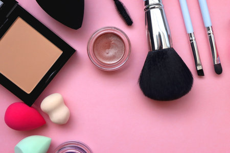 Various colorful beauty products on bright pink background. Top view.の写真素材
