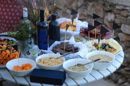 Table with various Mediterranean finger food. Garden party buffet. Selective focus.