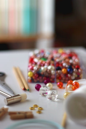 Various craft supplies on white background. Supplies for jewelry making, drawing and needlework....