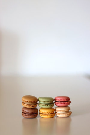 Stacks of colorful macarons on white table. Selective focus.の写真素材