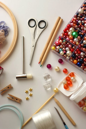 Various craft supplies on white background. Supplies for jewelry making, drawing and needlework....