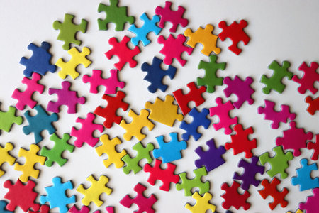Colorful jigsaw puzzle pieces on white background. Flat lay.の写真素材