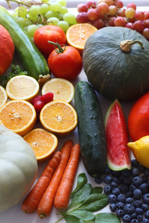Various seasonal fruits and vegetables on white background. Summer and fall produce. Selective focus.の写真素材