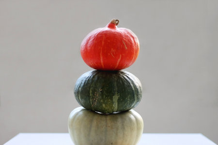 Pile of three different pumpkins on the table. Cute autumnal decoration. Selective focus.の写真素材
