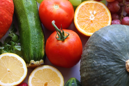 Various seasonal fruits and vegetables on white background. Summer and fall produce. Selective focus.の写真素材