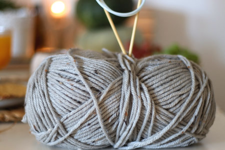 Pumpkins, various food and drinks, fall decorations, wool, books and candles on the table. Fall hygge at home. Selective focus.の写真素材