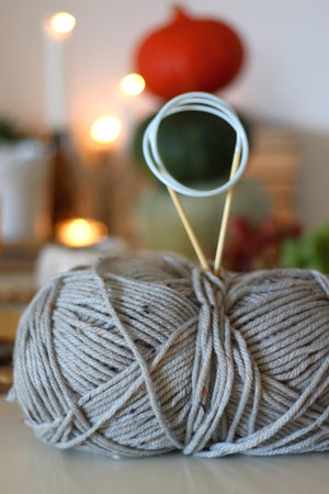 Pumpkins, various food and drinks, fall decorations, wool, books and candles on the table. Fall...