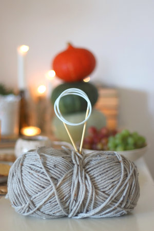 Pumpkins, various food and drinks, fall decorations, books and candles on the table. Fall hygge at home. Selective focus.の写真素材