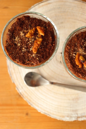 Two bowls of chia seed, chocolate and orange pudding. Healthy snack, wooden background. Top view.の写真素材