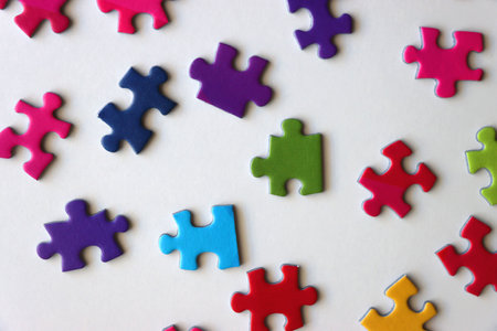 Colorful jigsaw puzzle pieces on white background. Flat lay.の写真素材