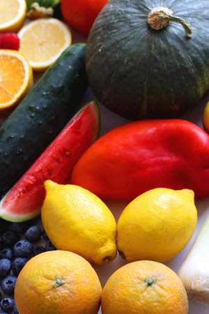 Various seasonal fruits and vegetables on white background. Summer and fall produce. Selective focus.の写真素材
