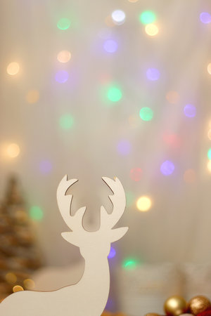 Various Christmas decorations, lit candles, cup of tea or coffee, cookies, books, presents and soft blanket on the table. Holiday hygge at home. Selective focus.の写真素材