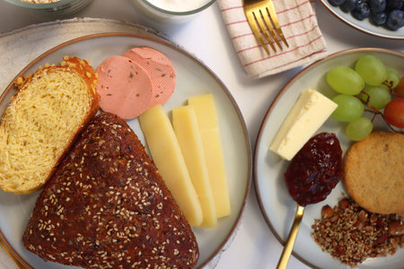 Assortment of various breakfast foods and drinks on the white table. Flat lay.の写真素材