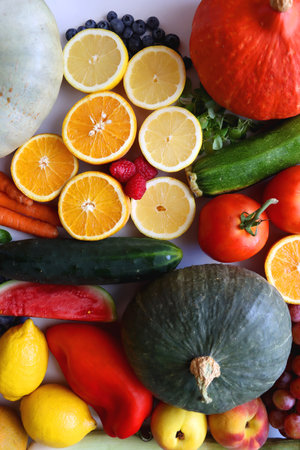 Various seasonal fruits and vegetables on white background. Summer and fall produce. Top view.の写真素材