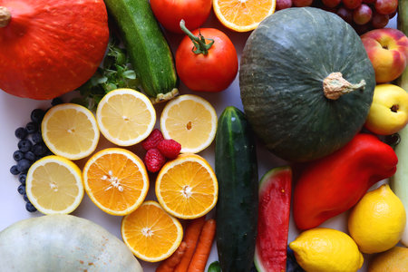 Various seasonal fruits and vegetables on white background. Summer and fall produce. Top view.の写真素材