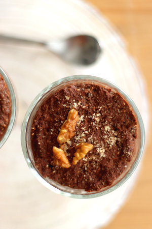 Two bowls of chia seed, chocolate and orange pudding. Healthy snack, wooden background. Top view.の写真素材