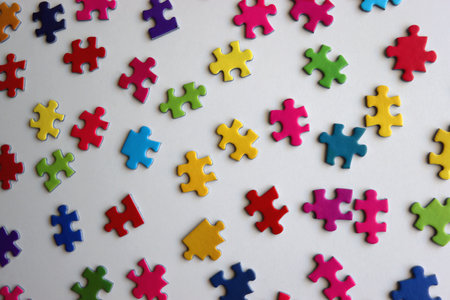 Colorful jigsaw puzzle pieces on white background. Flat lay.の写真素材