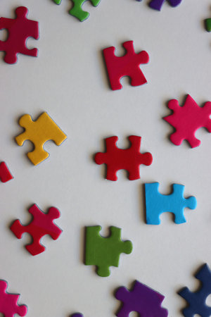 Colorful jigsaw puzzle pieces on white background. Flat lay.の写真素材