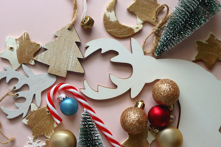 Various cute Christmas ornaments on pale pink background. Flat lay.の写真素材
