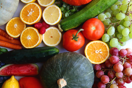 Various seasonal fruits and vegetables on white background. Summer and fall produce. Top view.の写真素材