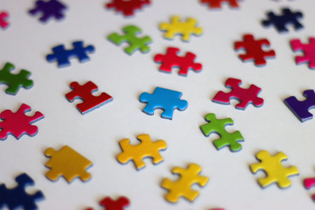 Colorful jigsaw puzzle pieces on white background. Selective focus.の写真素材