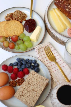 Assortment of various breakfast foods and drinks on the white table. Selective focus.の写真素材