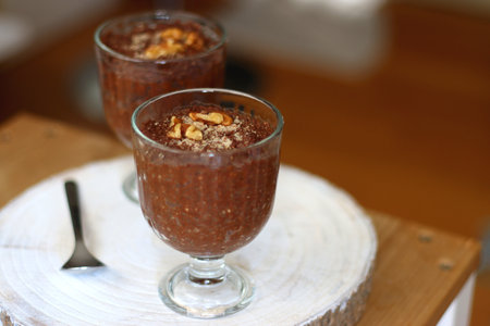 Two bowls of chia seed, chocolate and orange pudding. Healthy snack, wooden background. Selective focus.の写真素材