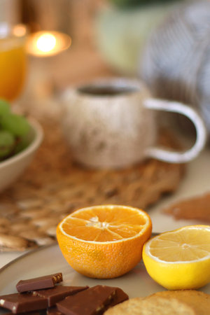 Pumpkins, various food and drinks, fall decorations, books and candles on the table. Fall hygge at home. Selective focus.の写真素材