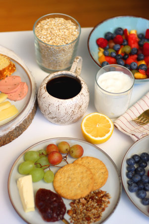 Assortment of various breakfast foods and drinks on the white table. Selective focus.の写真素材