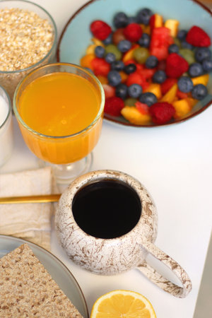 Assortment of various breakfast foods and drinks on the white table. Selective focus.の写真素材