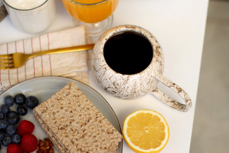 Assortment of various breakfast foods and drinks on the white table. Selective focus.の写真素材