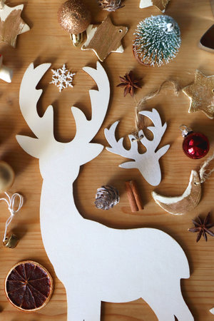 Various Christmas decorations in neutral colors on wooden background. Flat lay.の写真素材